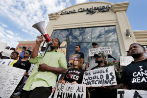 Demonstrators outside North Charleston City Hall on Wednesday morning to protest systemic racial killings of African-Americans. Credit Chuck Burton/Associated Press